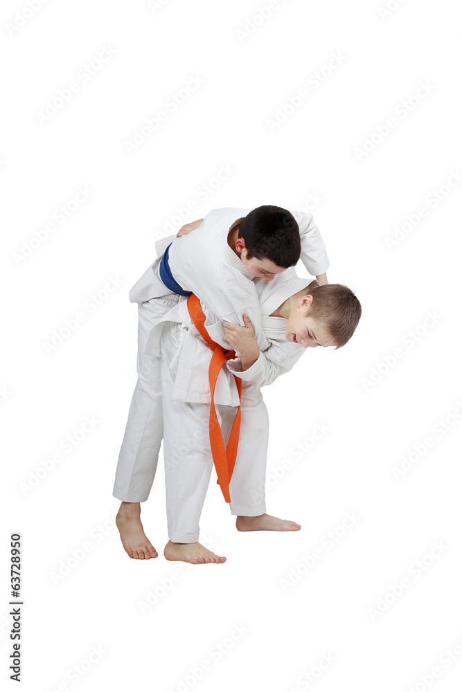 Capture for throw is performing athlete  with orange belt