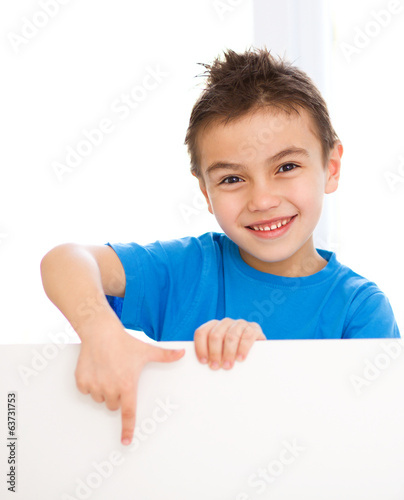 Cute boy is holding blank banner