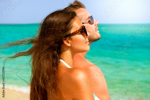 Happy Couple in Sunglasses Having Fun on the Beach. Summer