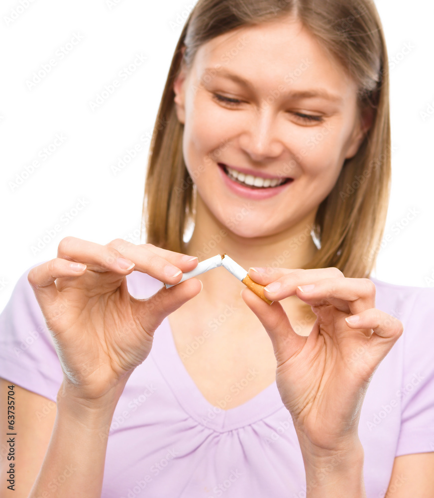 Young woman is breaking a cigarette Young woman is breaking a cigarette