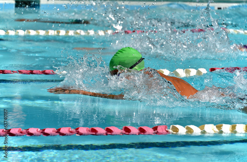 Profile of a breaststroke swimmer during a meet photo