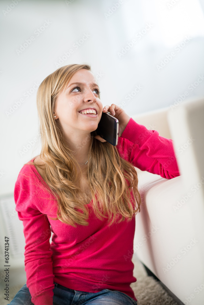 Fototapeta premium cheerful young woman making a phone call
