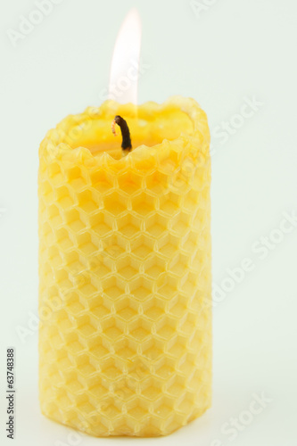 candle from honeycomb white background