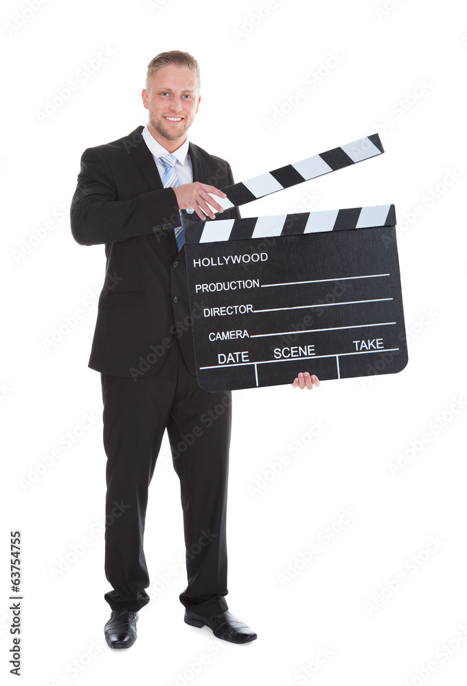 Businessman holding a blank clapper board with the arm Businessman holding a blank clapper board with the arm