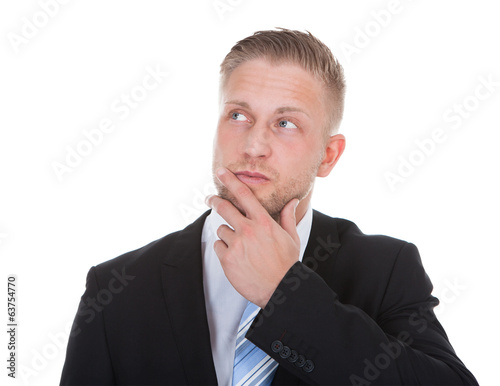Businessman standing deep in thought