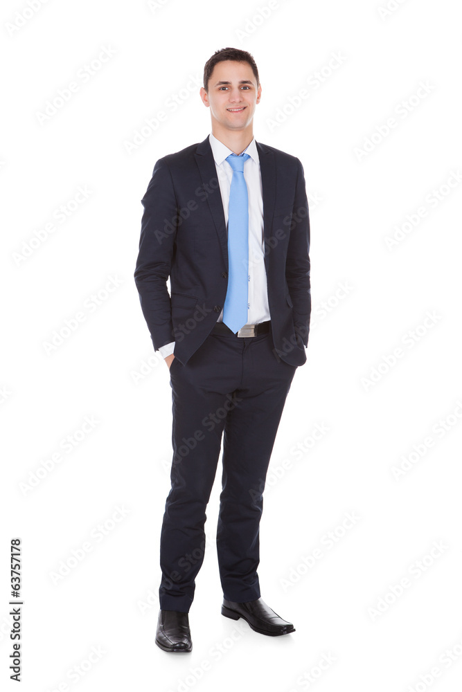 Confident Businessman Standing With Hands In Pockets Confident Businessman Standing With Hands In Pockets