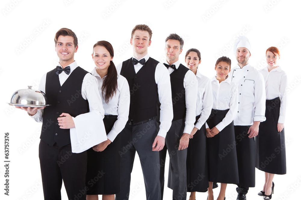 Large group of waiters and waitresses standing in row Large group of waiters and waitresses standing in row
