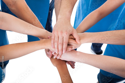 Group of cleaners stacking hands