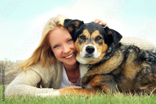 Smiling Woman Hugging Pet German Shepherd Dog photo