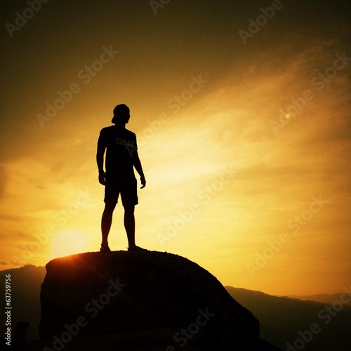 silhouette of man on sunrise background