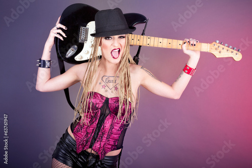 Beautiful woman punk rocker with electric guitar