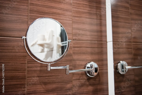 Round wall mirror for the bath.