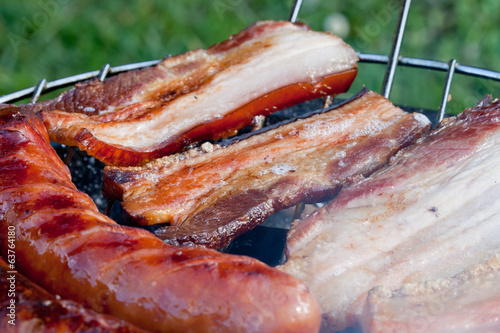 Sausages and bacon on the grill