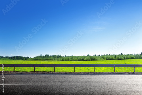 road and field of spring grass