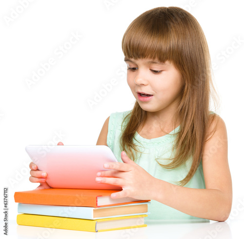 Young cheerful girl is using tablet