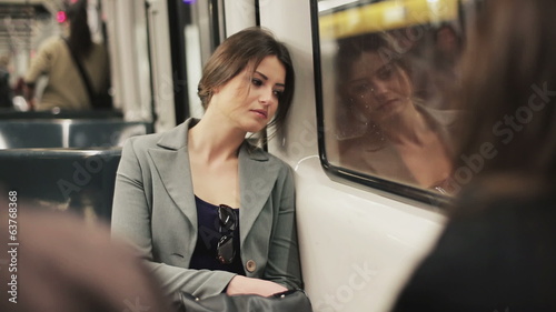 Sad woman sitting in the subway, steadycam shot