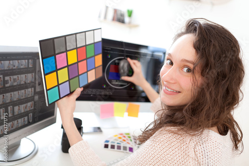 Woman photographer calibrate her screen photo