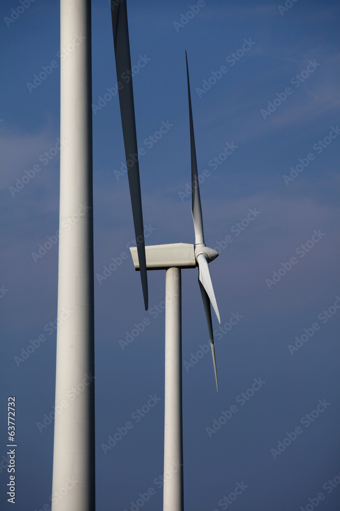 Two wind turbines against blue sky Two wind turbines against blue sky