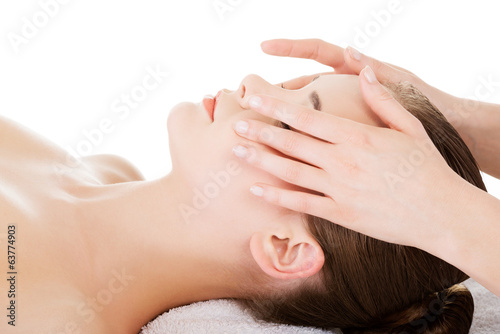 Relaxed woman enjoy receiving face massage