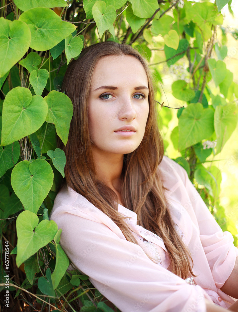Lovely young woman in the summer green garden Lovely young woman in the summer green garden