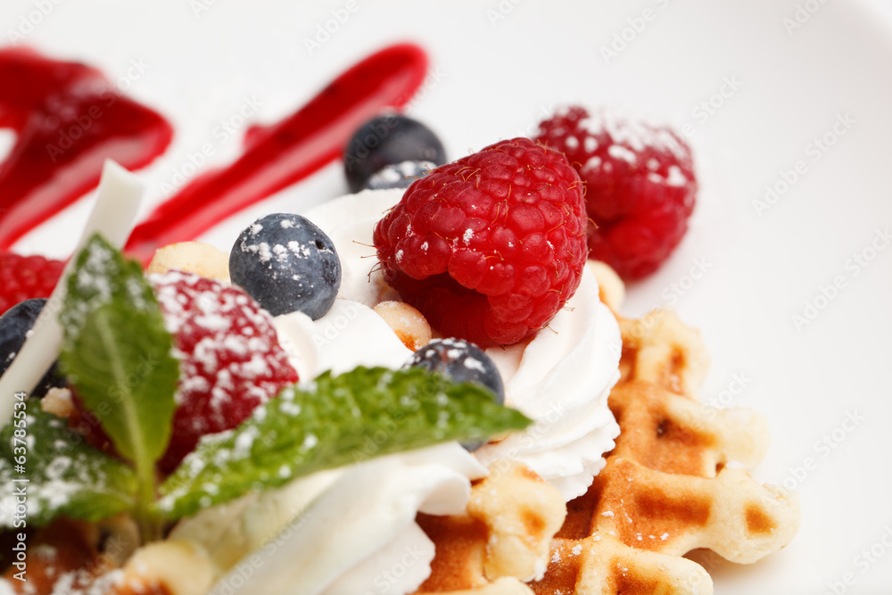 Waffle and cream topped with fresh berries Waffle and cream topped with fresh berries