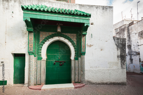 Green wooden gate of ancient mosque in Medina. Tangier, Morocco © evannovostro
