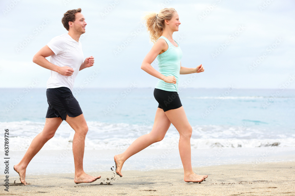 Couple running outdoors on beach Couple running outdoors on beach