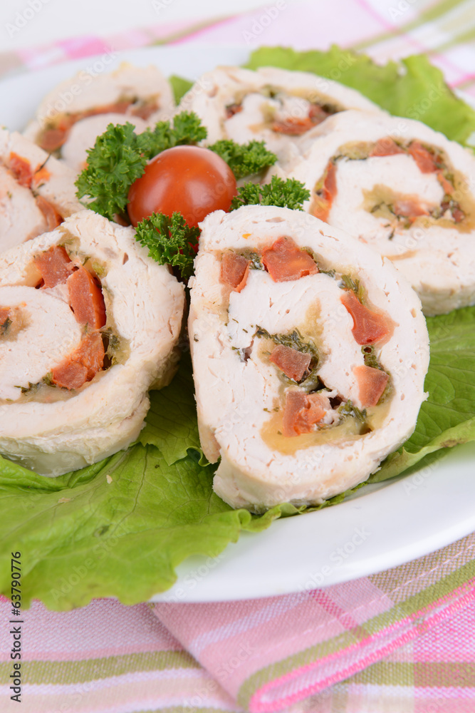 Delicious chicken roll on plate on table close-up Delicious chicken roll on plate on table close-up