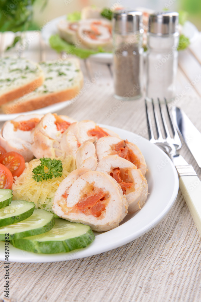 Delicious chicken roll on plate on table close-up Delicious chicken roll on plate on table close-up