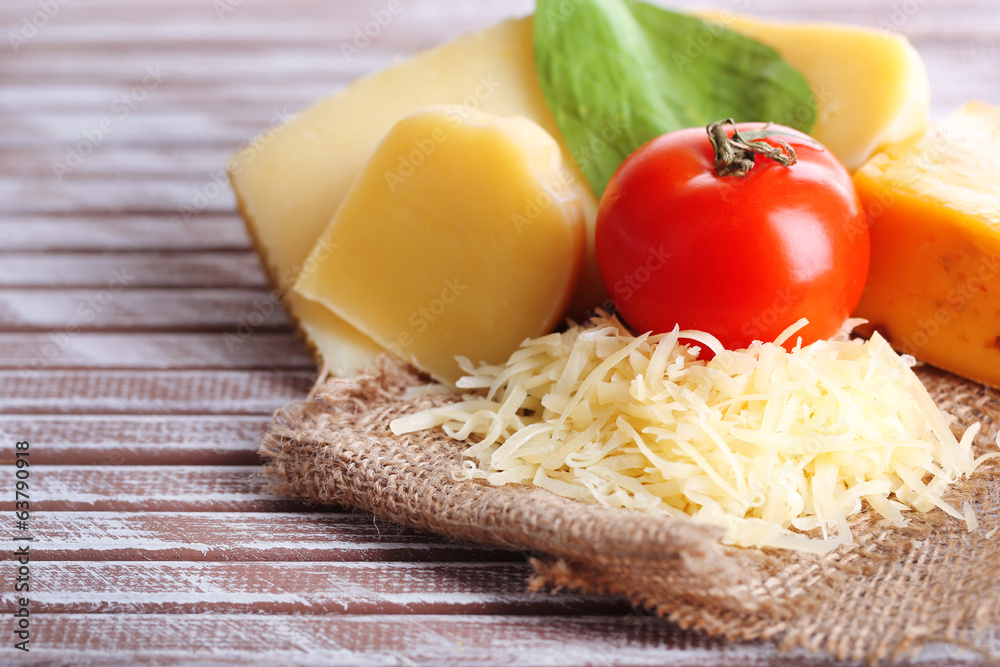 Different Italian cheese on wooden background