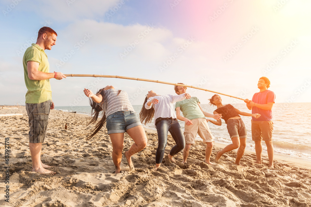 Friends Dancing Limbo at Beach - obrazy, fototapety, plakaty 
