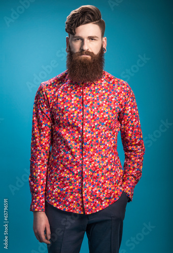 Stylish man with beard on blue background