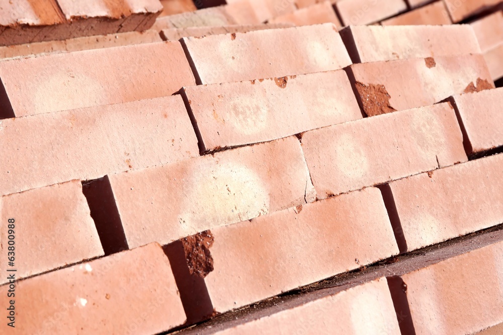 Stack of red clay bricks isolated background, XXXL