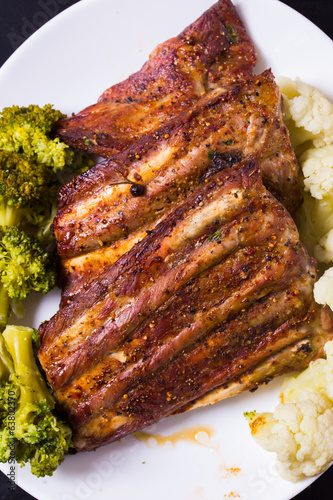 Grilled ribs porkmeat with cauliflower and broccoli photo