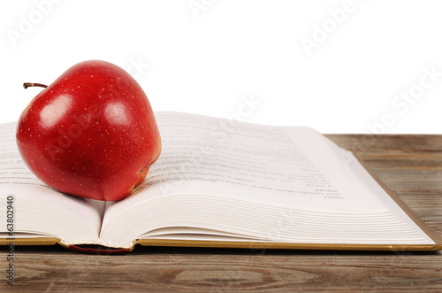 Open book with apple isolated on white background