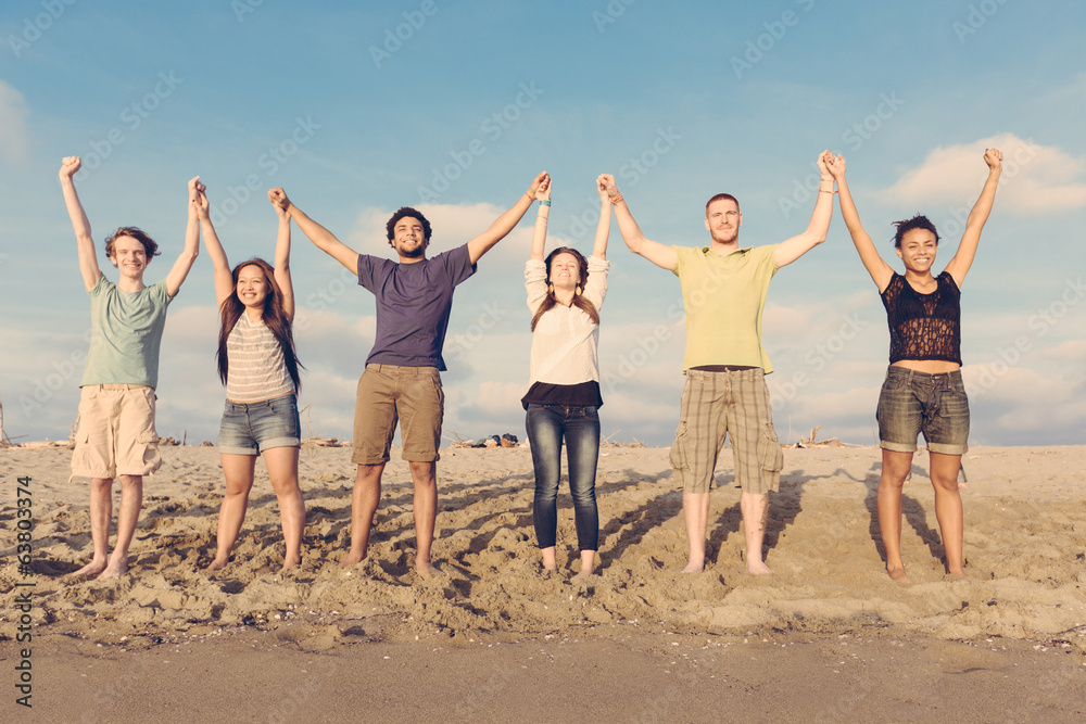 Obraz premium Multiracial Group of People with Raised Arms looking at Sunset