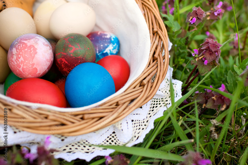 wicker basket with colorful easter eggs wicker basket with colorful easter eggs