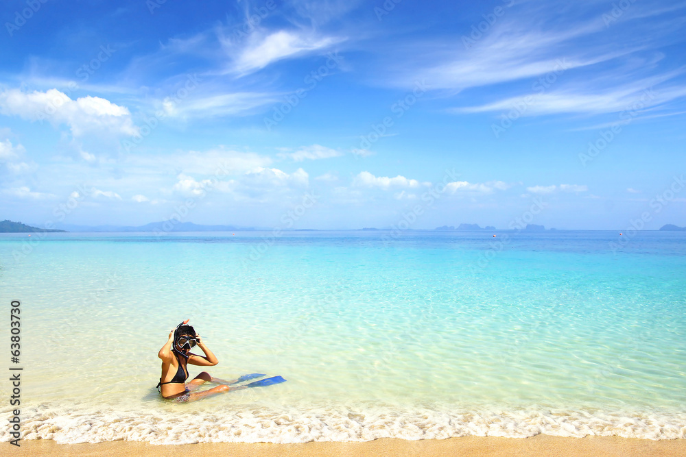 Woman on beach with snorkeling mask and fins. Woman on beach with snorkeling mask and fins.