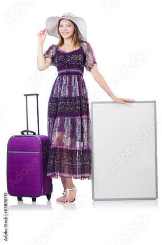 Woman in panama preparing for travel with suitcases and blankb