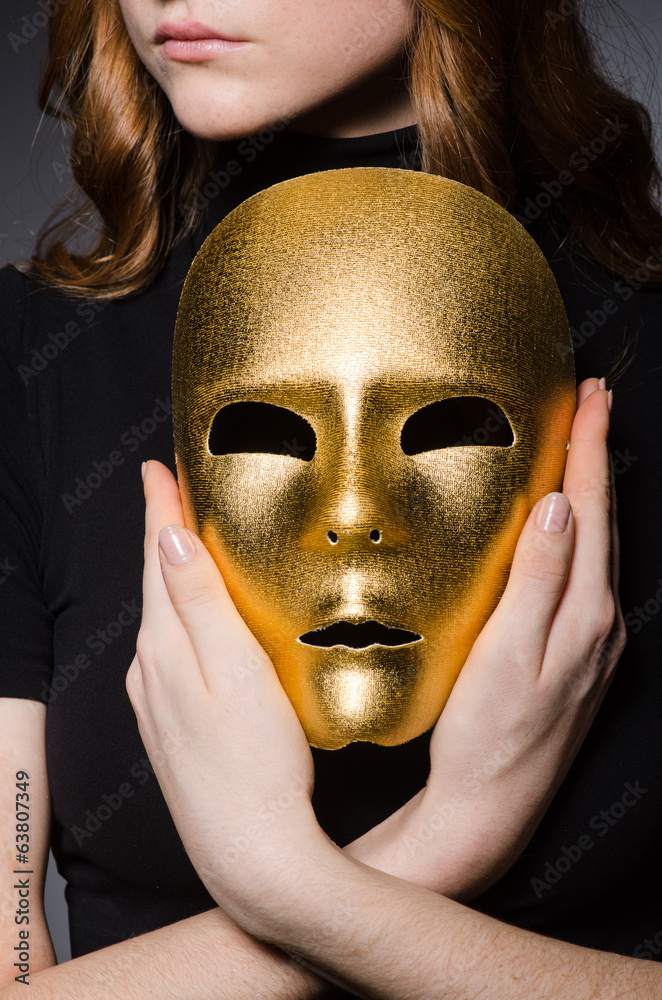 Redhead woman in hat iwith mask in hypocrisy consept against gr Redhead woman in hat iwith mask in hypocrisy consept against gr