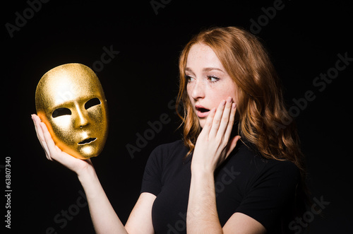 Quadro su tela Redhead woman iwith mask in hypocrisy consept against black  bac