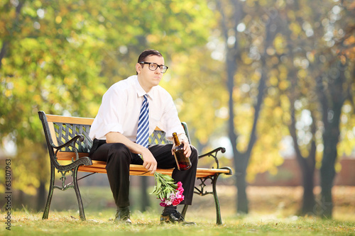 Lonely man drinking alcohol in park