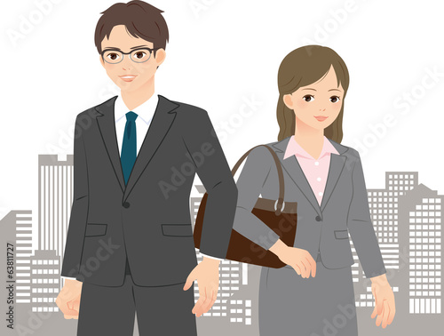 都市のビル群とスーツの男女