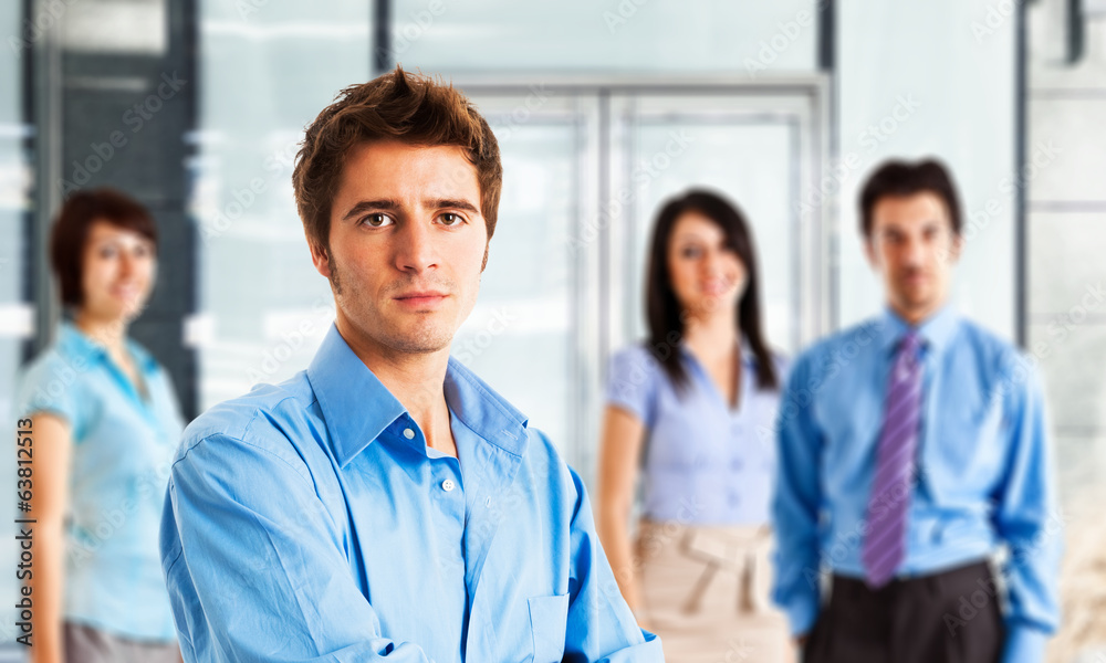 Young man in front of a group of people Young man in front of a group of people