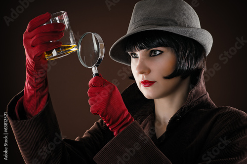 woman detective examines the evidence