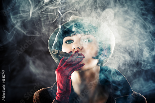 beautiful glamorous woman in retro style with cigar