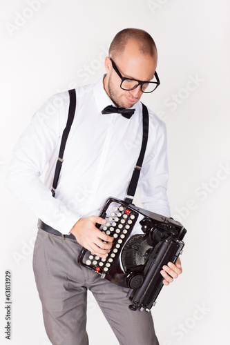 Portrait of a young businessman with a typewriter
