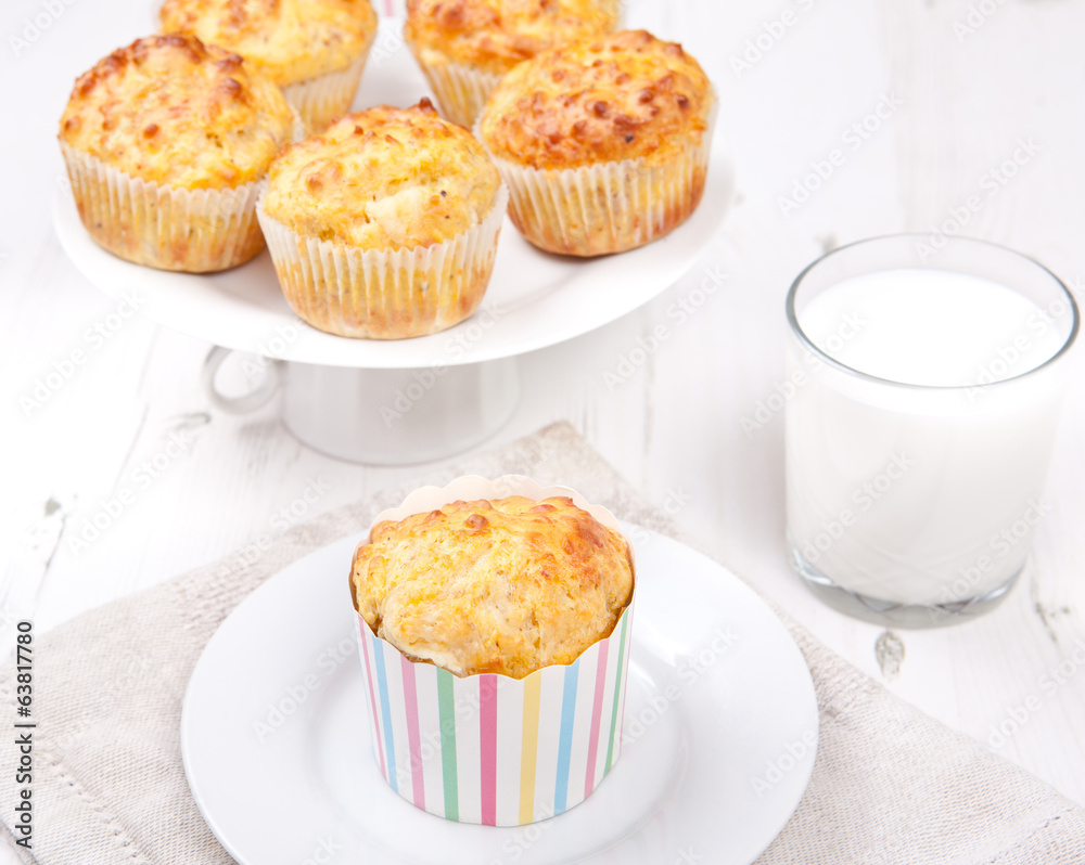 Savory cheese and bacon muffins on the white table Savory cheese and bacon muffins on the white table