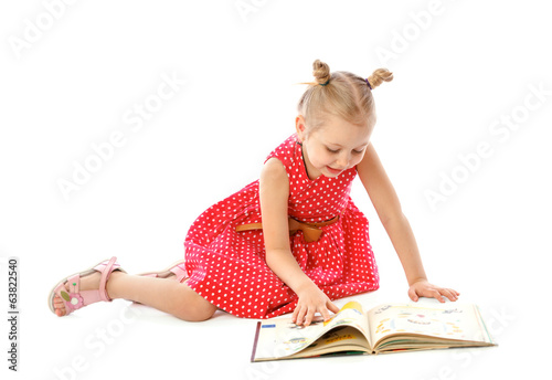 portrait of a little girl reading books, sitting on the floor