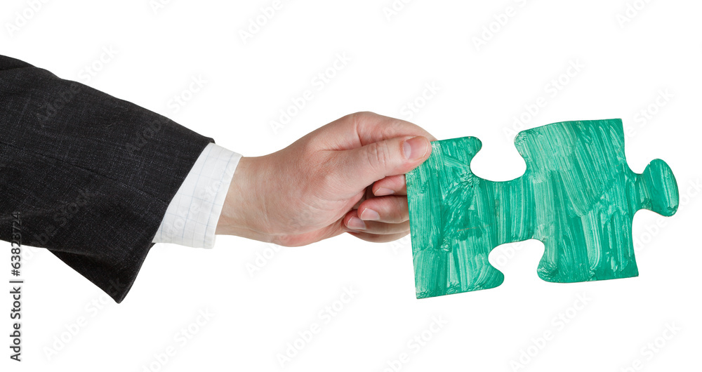 male hand with painted green puzzle piece